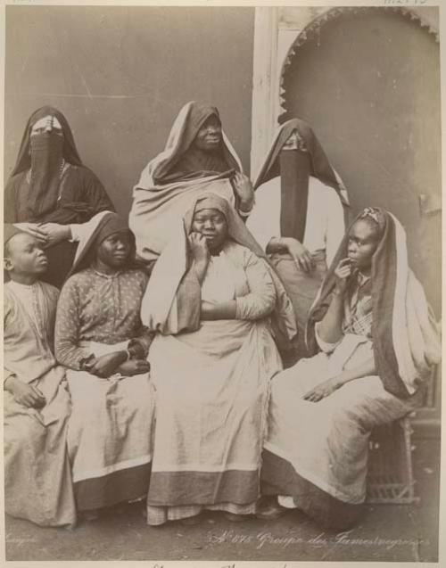 Group of women sitting in front of a building