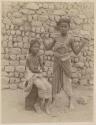 Two boys in front of a wall