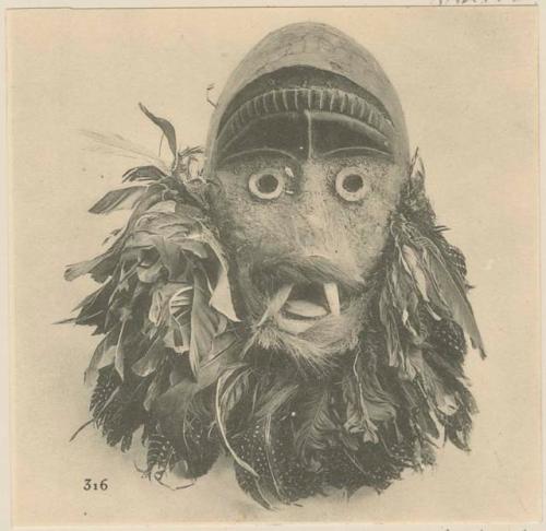 Wooden mask decorated with feathers and hair