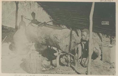 Man with still under a shelter