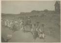 Traveler and his luggage being carried by a group of people