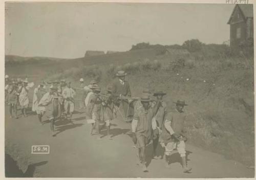 Traveler and his luggage being carried by a group of people