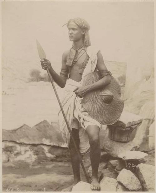 Man standing and holding spear