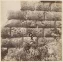 Man standing in front of stone wall