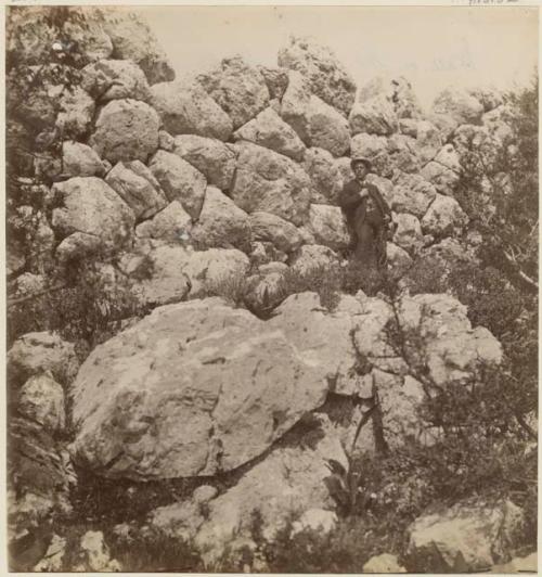 Man standing in front of stone wall