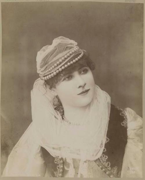 Studio portrait of a woman with headdress