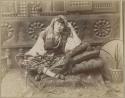 Studio portrait of a woman sitting with a hookah