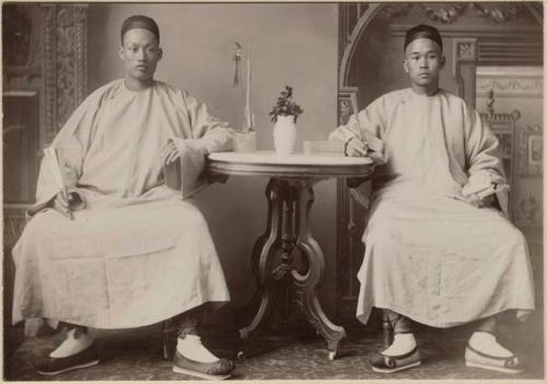 Portrait of two males sitting at a table