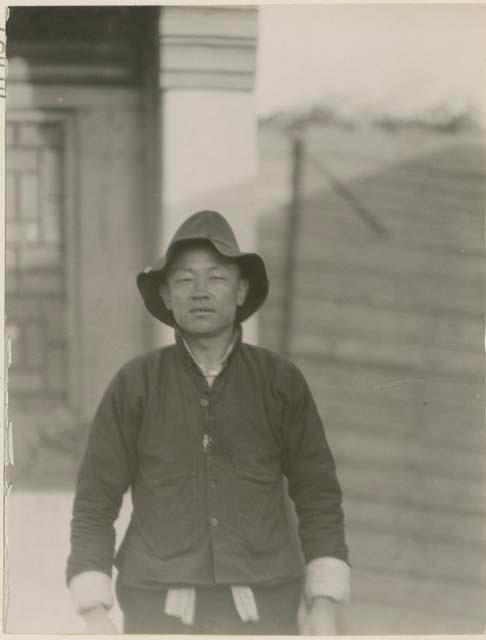 Portrait of Chinese taxidermist in hat