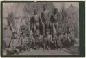 Group of people in front of a hut