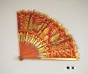 Fan such as used by a girl dancer in the legong dance drama or by a +