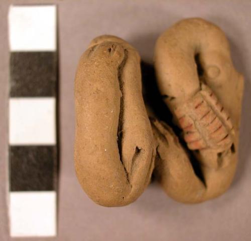 Ceramic human figurine, seated female, missing head, wearing bracelet