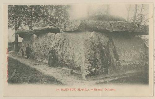 People standing next to dolmen