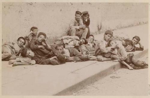 Group of men and boys on sidewalk