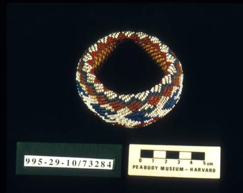 Coiled fully beaded trinket basket of willow with diamond and arrow motif