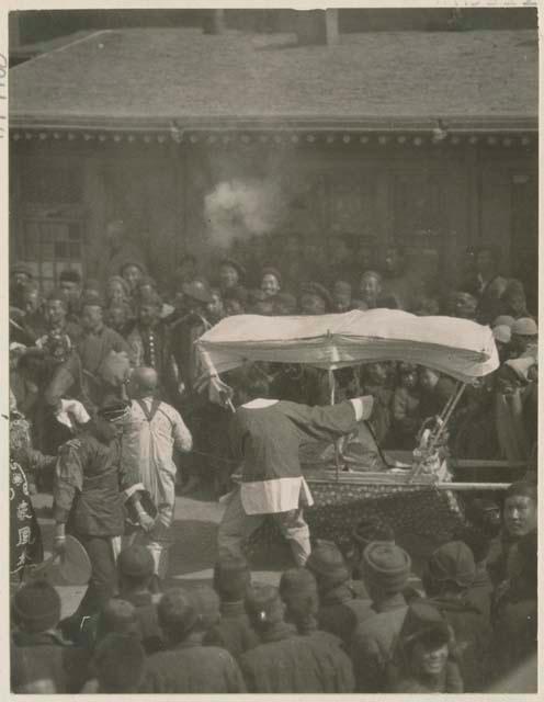 Leading mummer led through inn courtyard