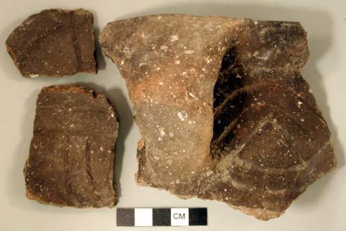 Ceramic, earthenware rim, body, and handle sherds, incised with possible Ramie design, two with incised rim, shell-tempered; two rim sherds and two body sherds crossmend; two rim sherds crossmend