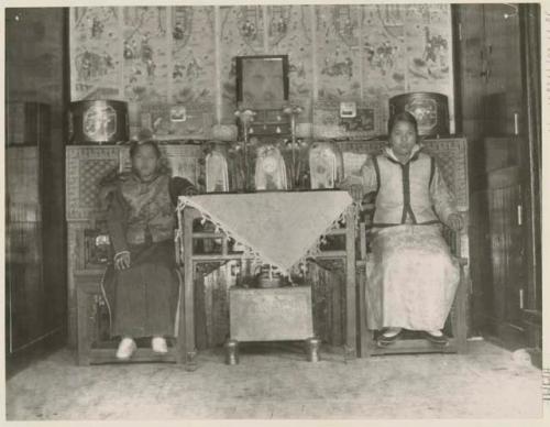 Bride's two sisters sitting at table with gifts