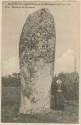Woman standing next to stone monument