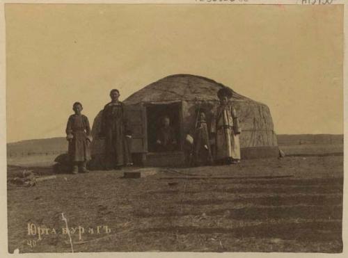 People in front of a hut