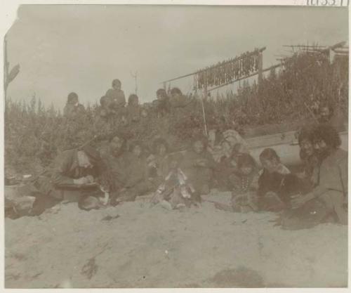 Group on beach, with man mapping coast