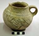 Black on white pottery jug