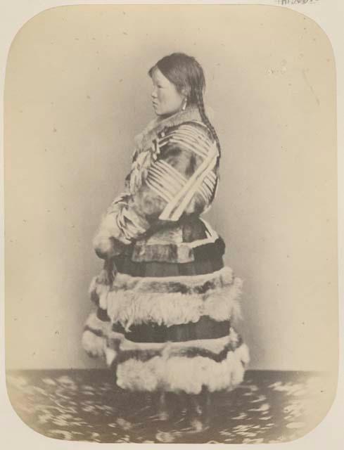 Side view of woman in long coat and boots