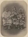 Three people in fur clothing