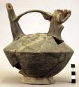 Badly broken black stirrup pot