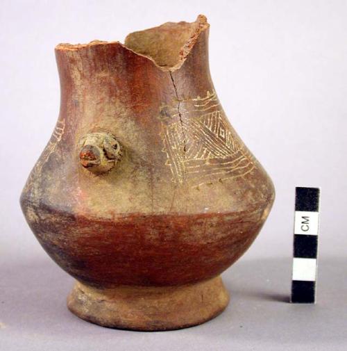 Maroon incised ware effigy jar - broken mouth, linear design & annular base