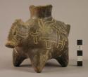 Black animal effigy vessel with incised design (Olmec tradition?).