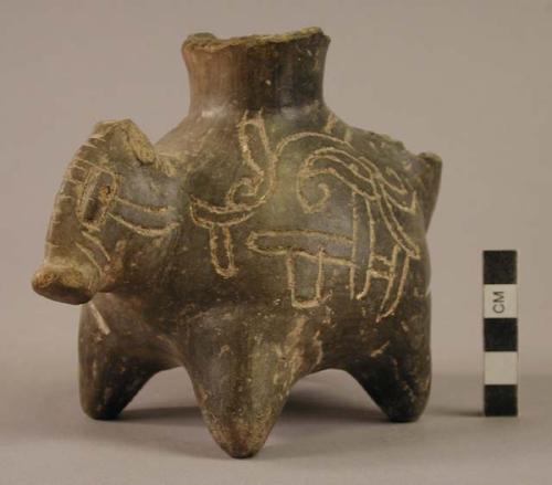 Black animal effigy vessel with incised design (Olmec tradition?).