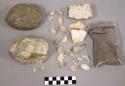 2 pieces bone; 17 pcs stone; large stone, labeled n-1e2-69; bag charcoal bits &