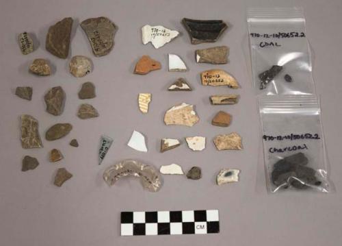 23 pieces of stone chipping debris, 2 unworked stones, 7 charcoal fragments, 3 coal fragments, 1 burned bone fragment, 1 kaolin pipe stem, 1 kaolin pipe bowl, 1 coarse earthenware sherd, 1 flat aqua glass fragments, 1 curved milk glass fragment, 1 colorless glass vessel rim, 1 stoneware body sherd, 1 porcelain body sherd, 2 redware body sherds, 7 white refined earthenware body sherds, 2 factory decorated slip sherds