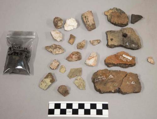 2 partially reconstructed pots, 12 sherds, charcoal, quartz, stone chips, biface