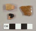 Lead-glazed red earthenware sherds, one with black glaze on both sides