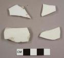 Porcelain fragments, including one with overglazed polychrome floral decoration