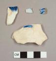 Pearlware sherds with blue on white transfer printed decoration, including one feather-edged plate rim sherd