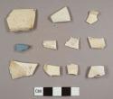 Creamware fragments, one with blue decoration, including one plate rim, one plate marly, and a footring base fragment possibly to a cup