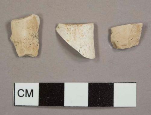 Kaolin/White ball clay pipe bowl fragments, two with ash residue on interior and one with "FR" stamped into the exterior