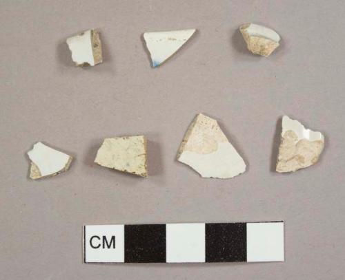 Pearlware sherds, including threeplate rim sherds from different vessels and one bowl or cup footring fragment, one of the rim sherds has blue decoration on it