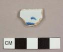 Tin-glazed earthenware rim sherd to a bowl with a handpainted blue design on the exterior