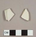 White salt-glazed stoneware sherds, including one plate base fragment with smal foot ring