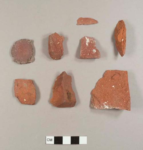 Brick fragments, including one flat, round brick disc