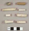 White ball clay/Kaolin pipe stem fragments, one with 4/64th inch bore hole, five with 5/64th inch bore hole, and 2 with 6/64th inch bore hole; one with "Depose" stamped on it and another with a painted and molded floral motif and "L. Fiolet / St. O[...]" stamped on it