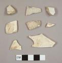 Miscellaneous white earthenware sherds, including five creamware sherds, one unglazed sherd, one possible white salt-glazed stoneware or burnt whtieware, and one ironstone platter rim sherd