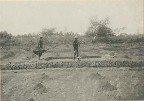 Men constructing a leach