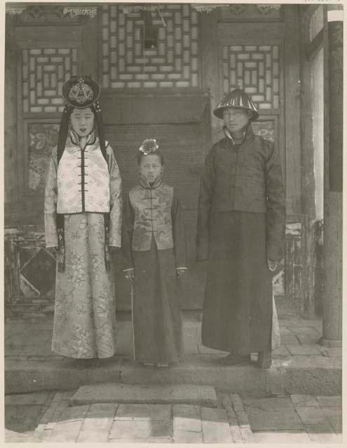 A Manchu bride and groom in wedding clothes with bride's sister