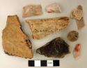 Coarse earthenware body sherds, some undecorated, some cord impressed; animal bone fragment, with cut marks; chipped stone, prismatic blades and flakes; chipped stone, projectile point, stemmed, broken tip; ground stone, round object; mica fragments
