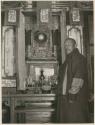Chi Lama before the shrine in his home